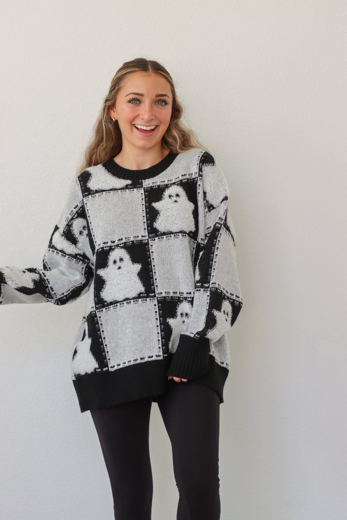 girl wearing black & white ghost sweater