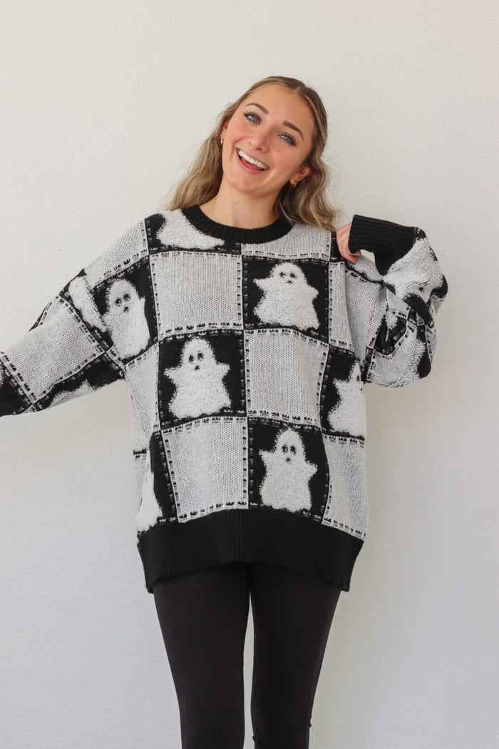 girl wearing black & white ghost sweater