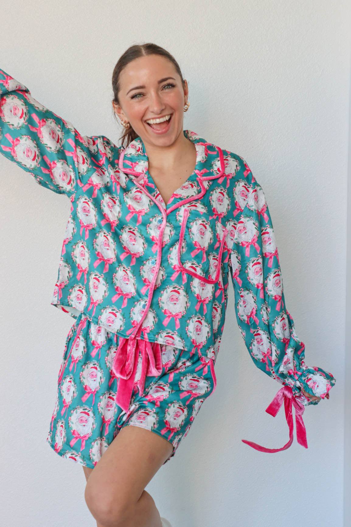 girl wearing teal and pink silk santa pajamas