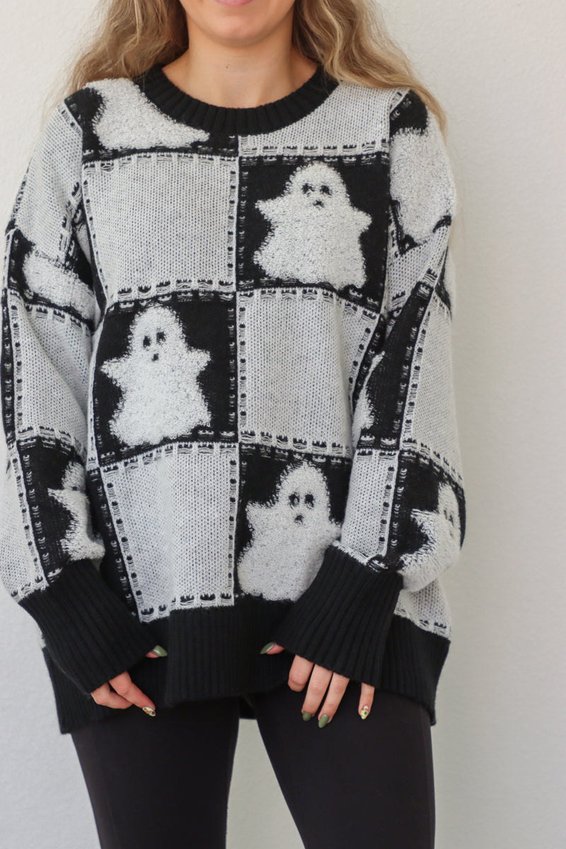 girl wearing black & white ghost sweater