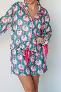 girl wearing teal and pink silk santa pajamas