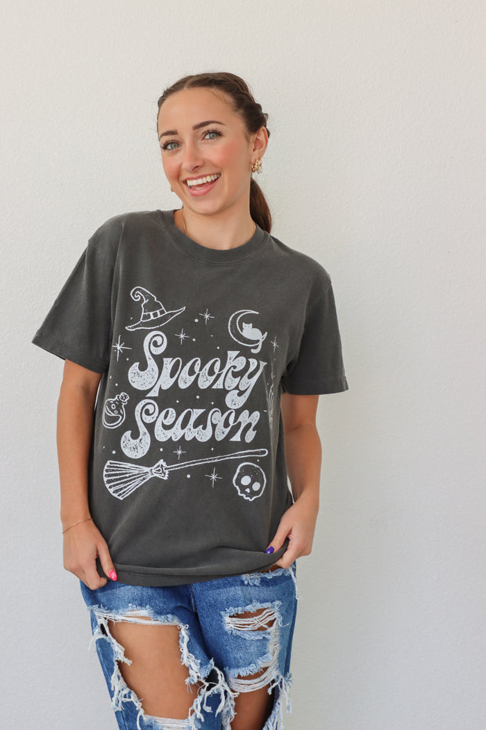 girl wearing dark gray "spooky season" tee