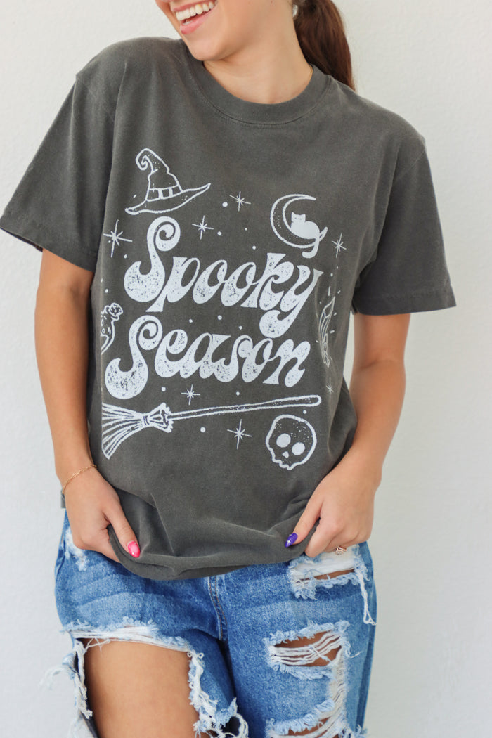 girl wearing dark gray "spooky season" tee