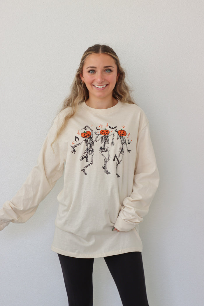 girl wearing cream dancing skeleton graphic longsleeve tee