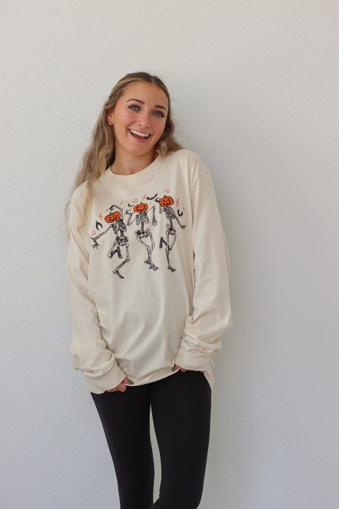 girl wearing cream dancing skeleton graphic longsleeve tee