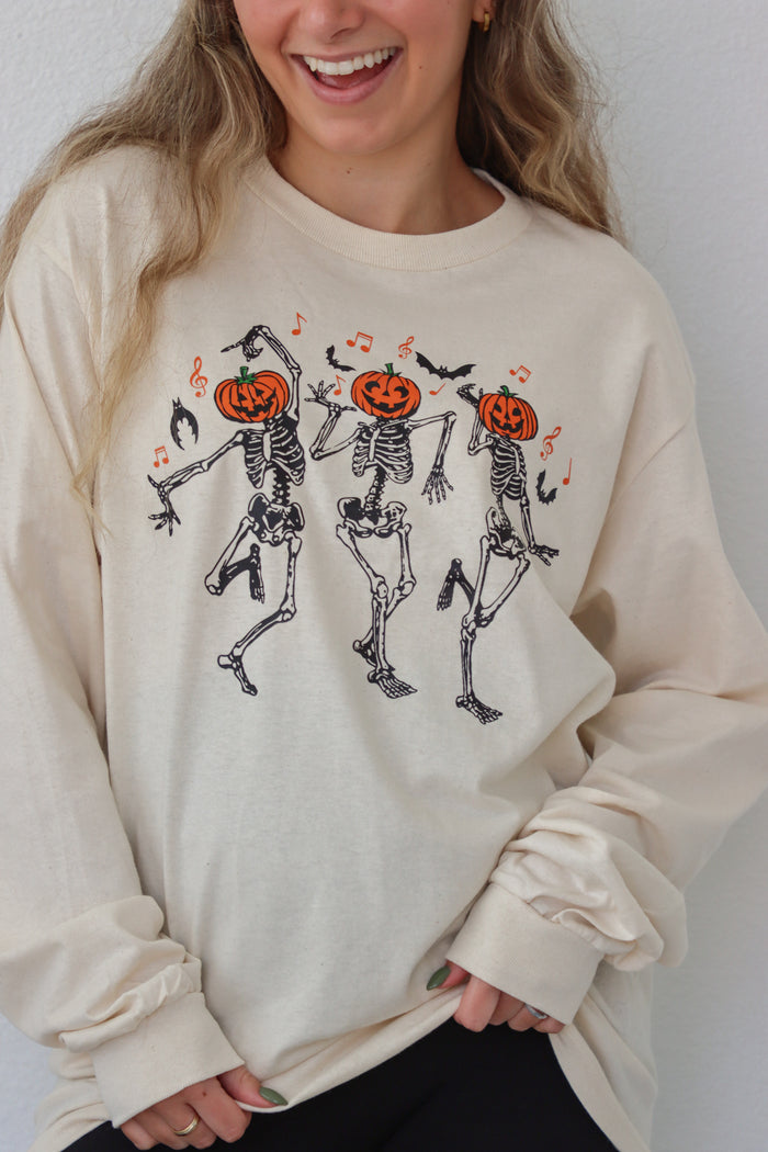 girl wearing cream dancing skeleton graphic longsleeve tee