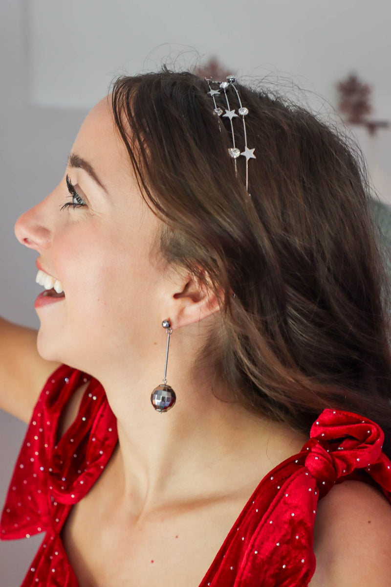 girl wearing silver disco ball earrings