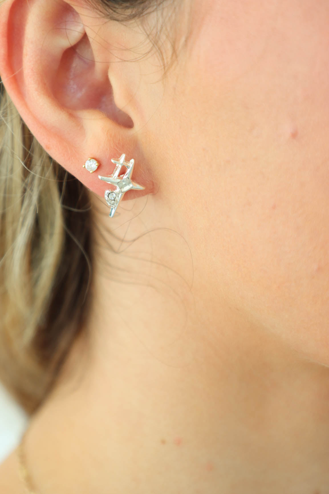 girl wearing silver star earrings