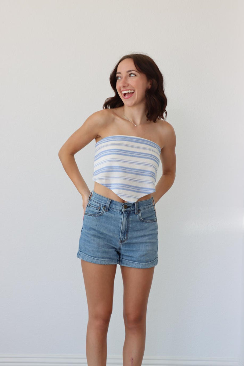girl wearing light blue and white striped strapless top