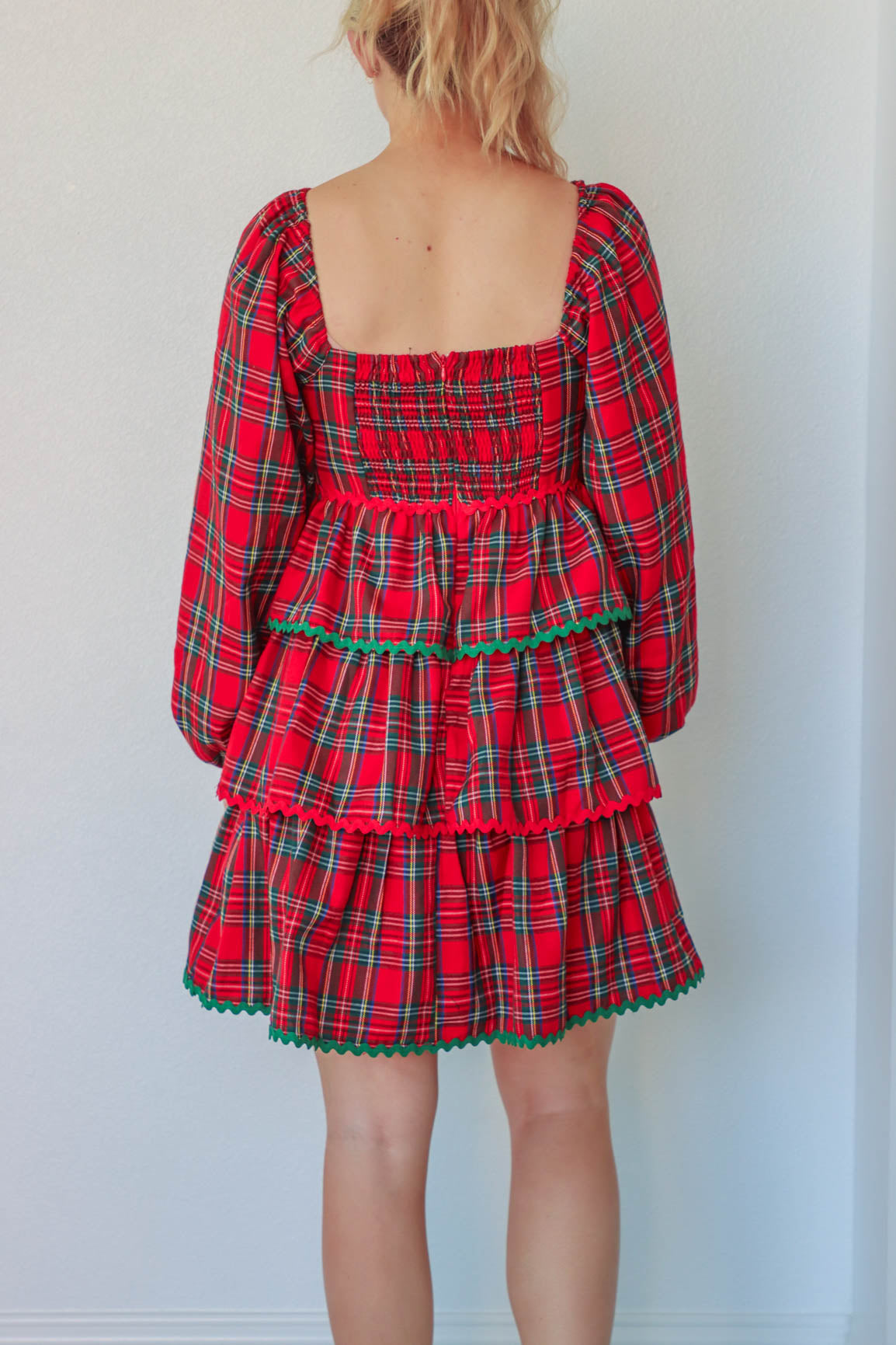 girl wearing red plaid holiday dress