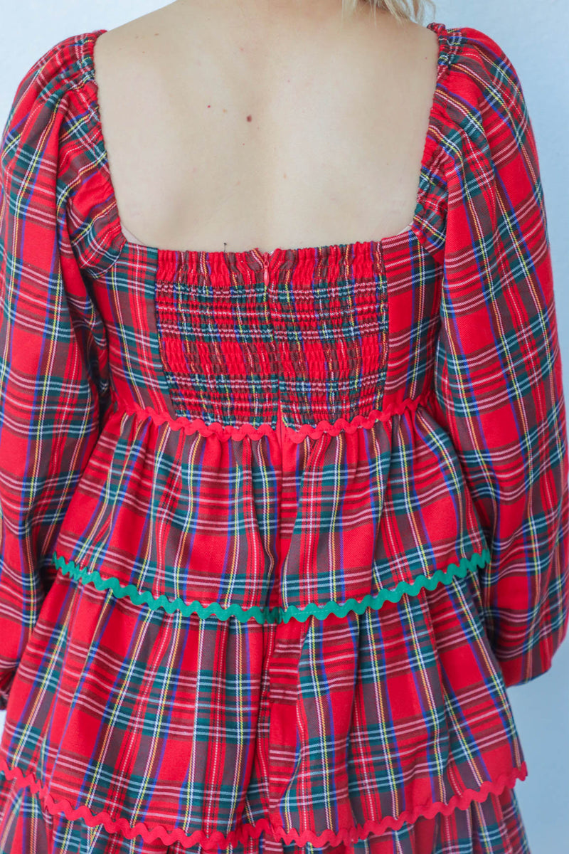 girl wearing red plaid holiday dress