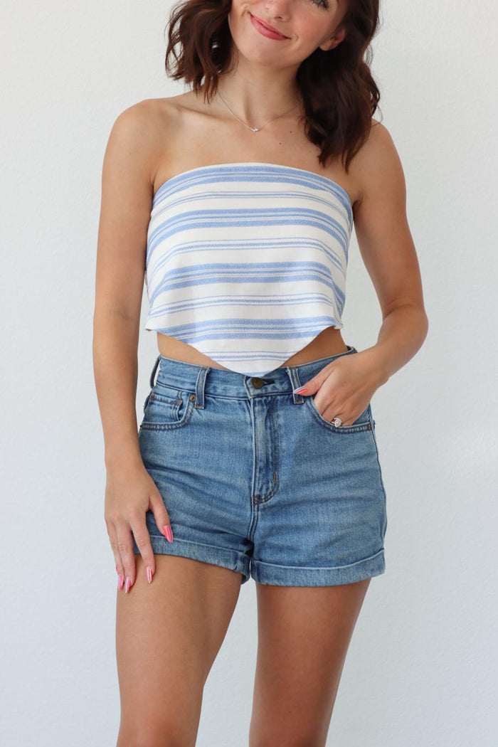 girl wearing light blue and white striped strapless top