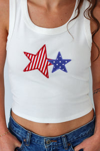 White tank top with red and blue stars worn by a person