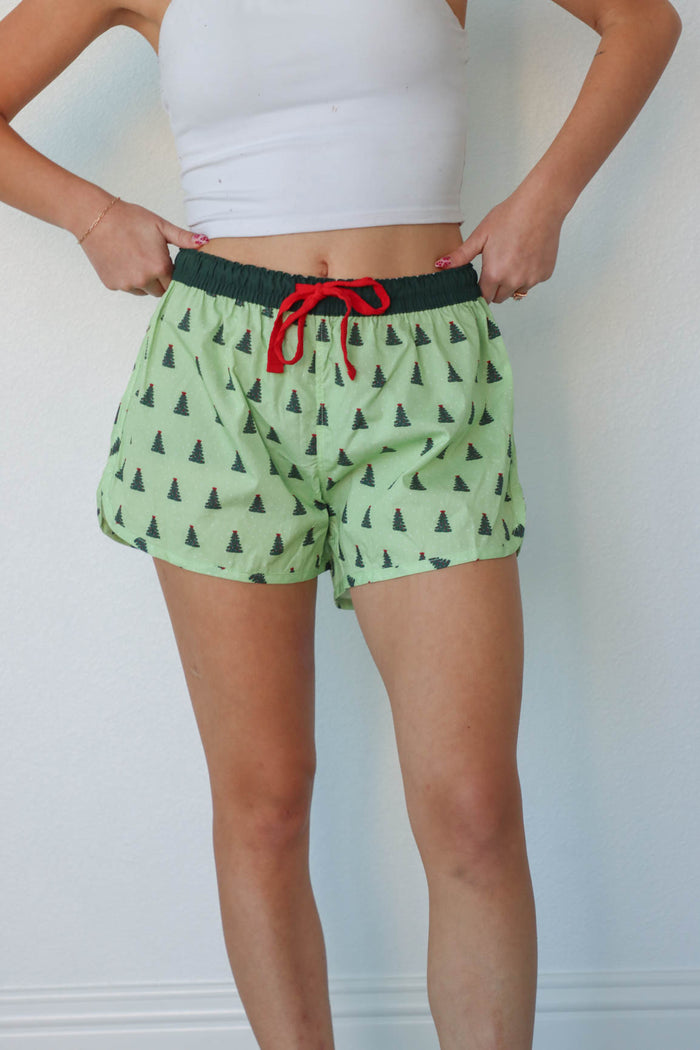 girl wearing green christmas tree pajama shorts