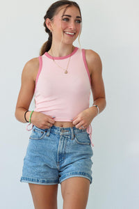 girl wearing light pink tank top with ruched side detailing