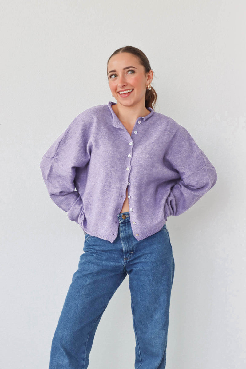 girl wearing light purple cardigan