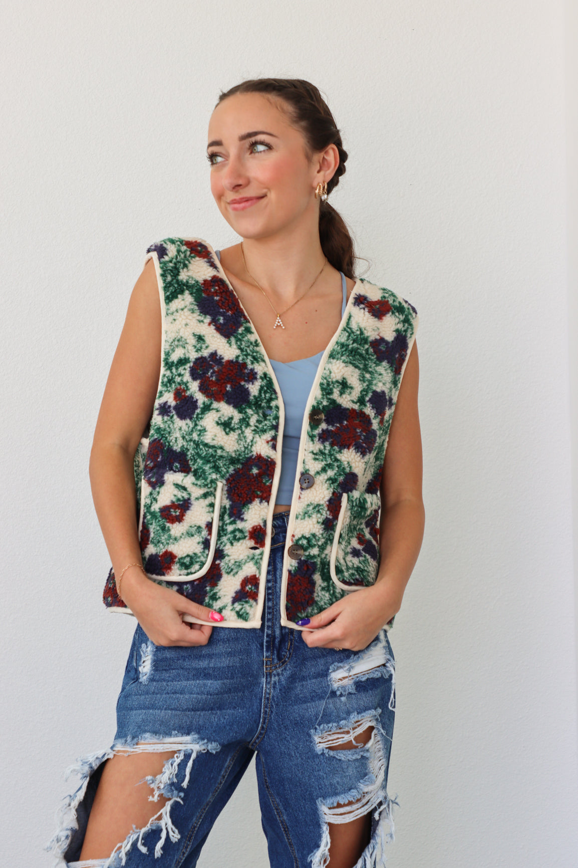 girl wearing fleece floral vest