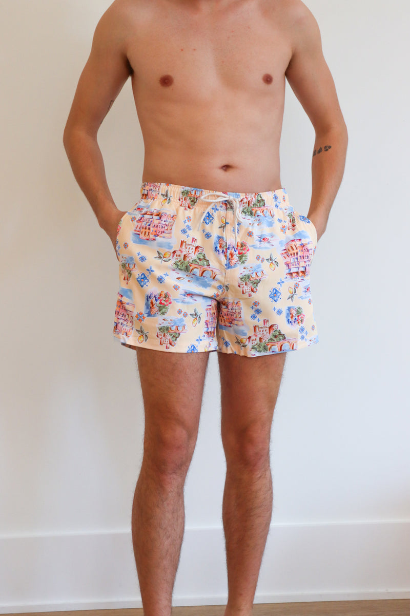 man wearing cream italian patterned swim trunks