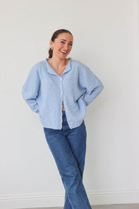 girl wearing light blue cardigan