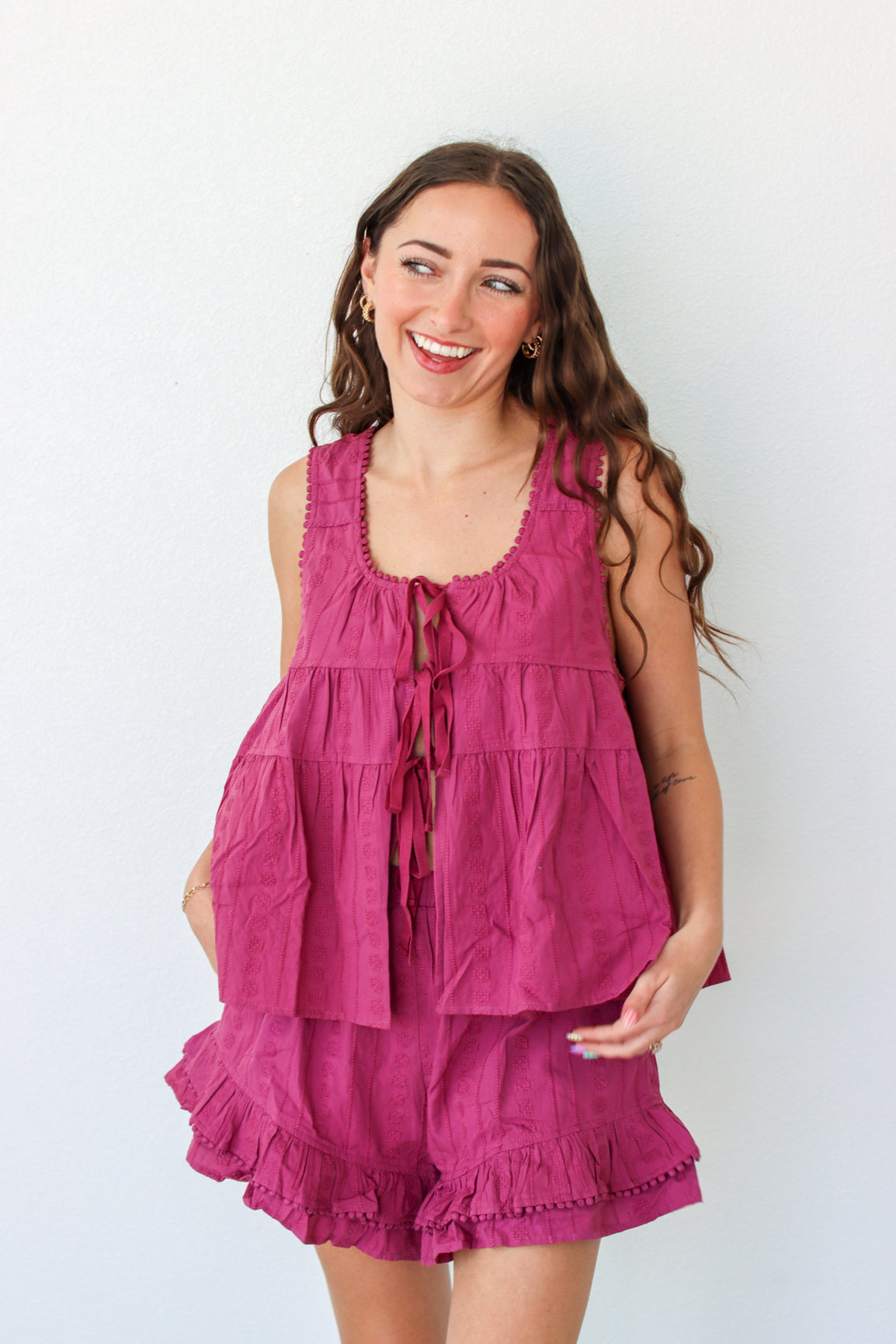 Woman wearing a purple outfit set against a white background