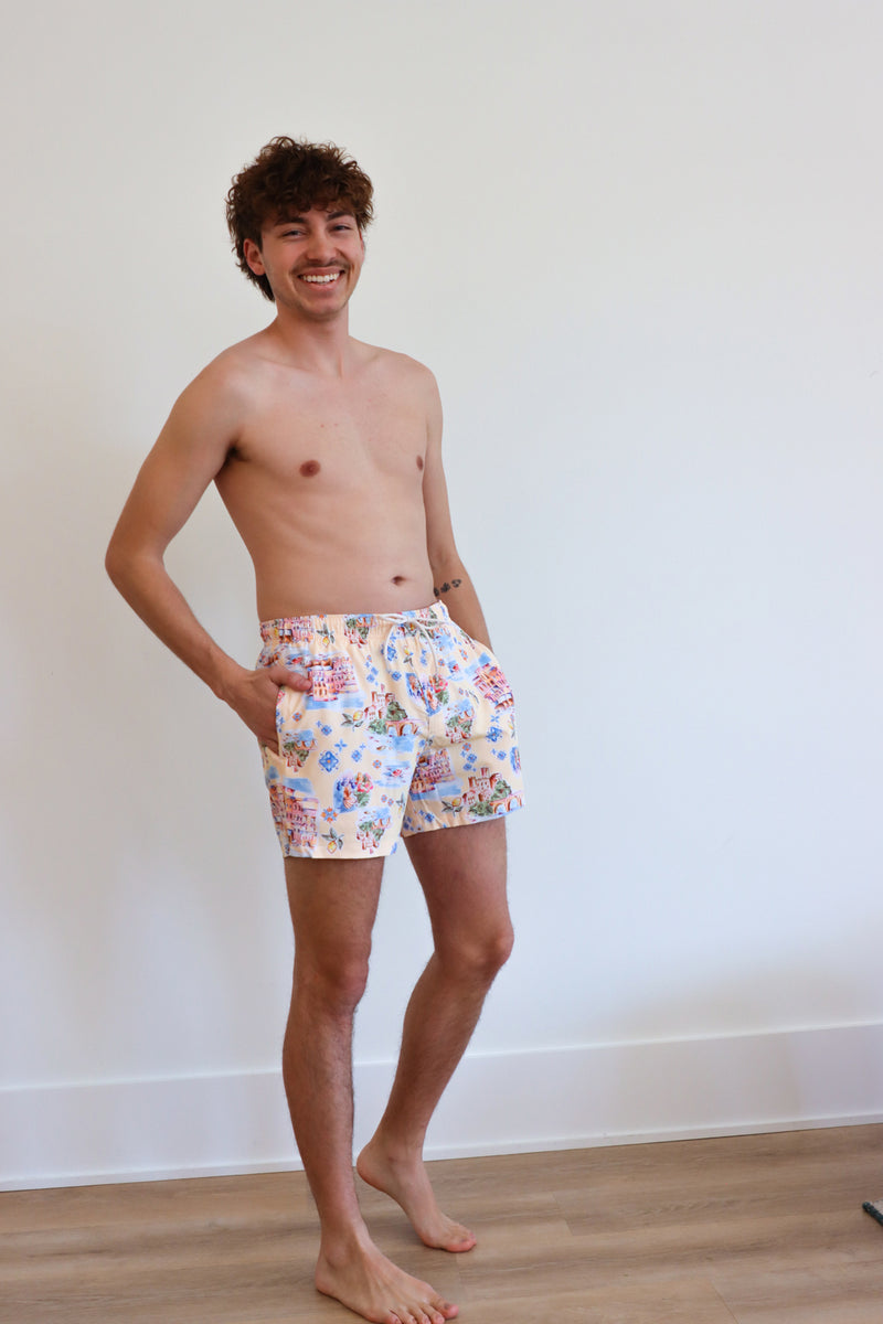 man wearing cream italian patterned swim trunks