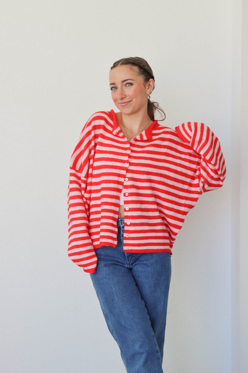 girl wearing red and pink striped cardigan