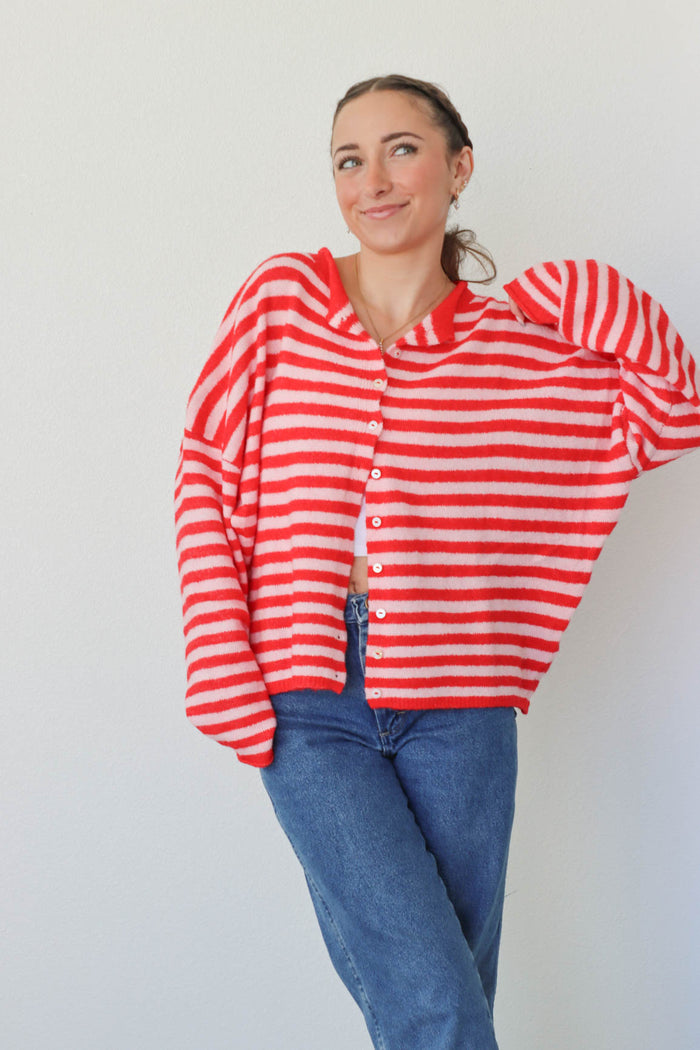 girl wearing red and pink striped cardigan