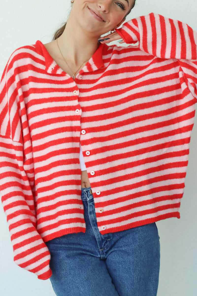 girl wearing red and pink striped cardigan