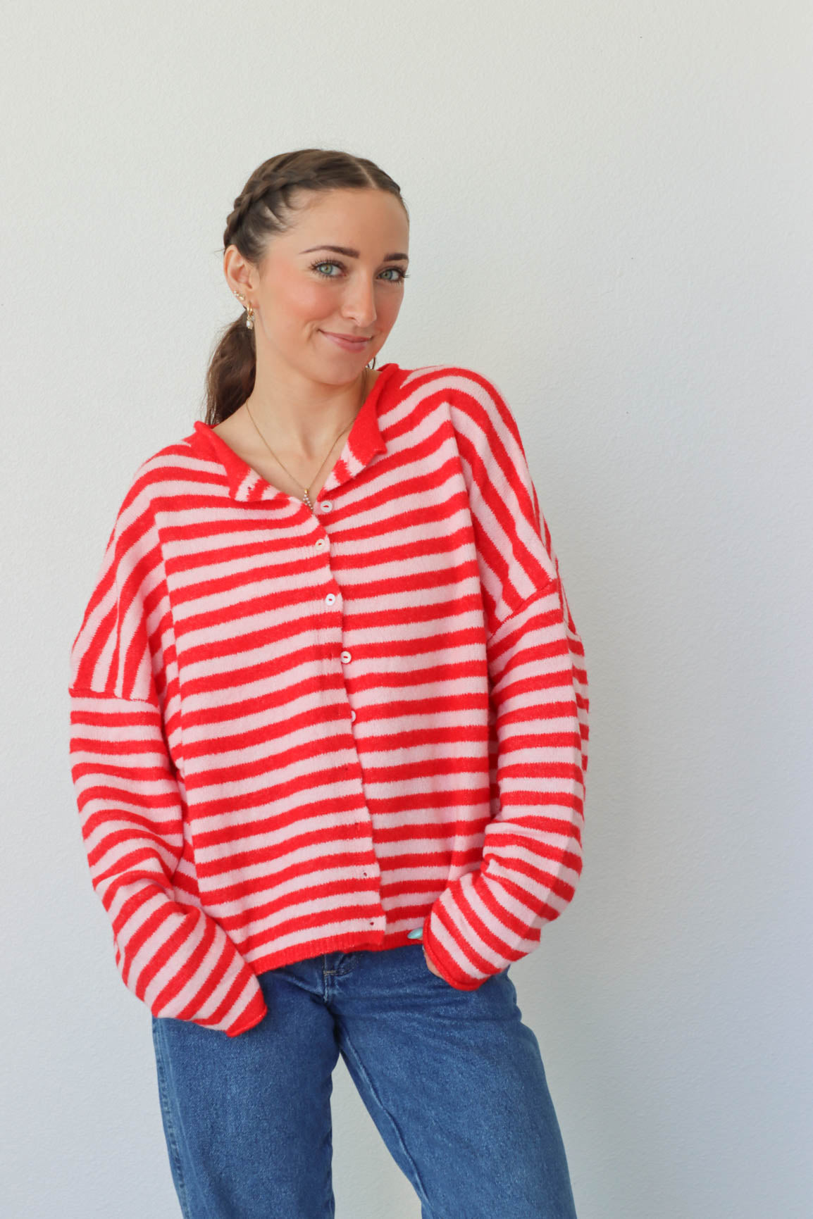 girl wearing red and pink striped cardigan