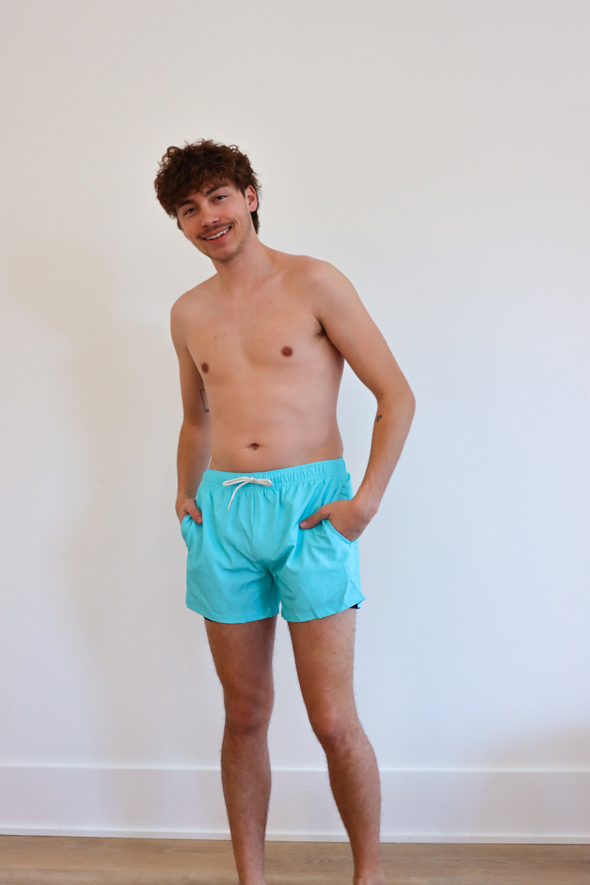 man wearing blue swim trunks