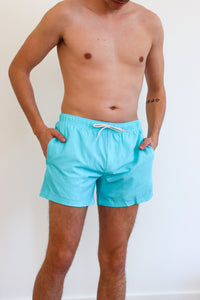 man wearing blue swim trunks