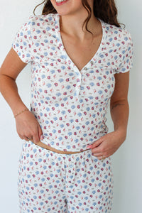 Close up of woman wearing a short sleeve top and pant PJ set with seashell prints 