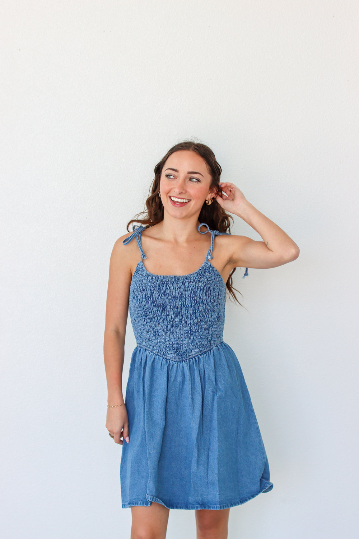 Woman wearing a blue dress against a white background