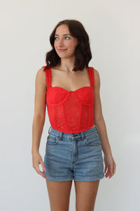 girl wearing red corset top