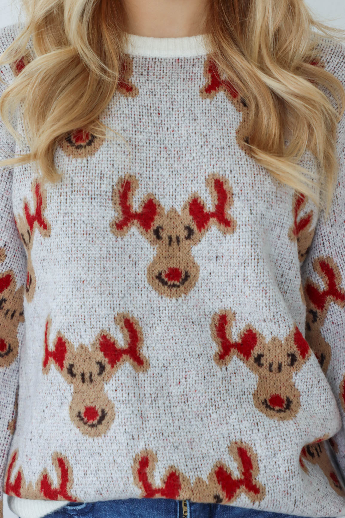 girl wearing knit reindeer sweater