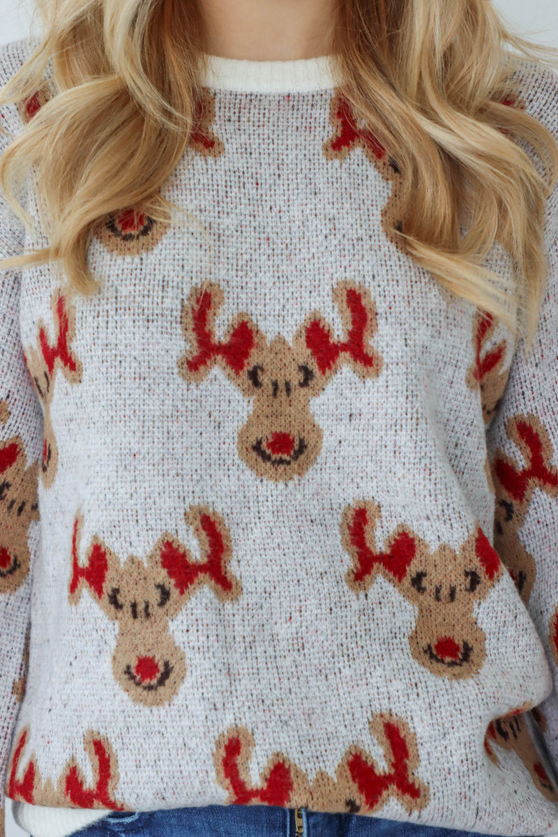 girl wearing knit reindeer sweater