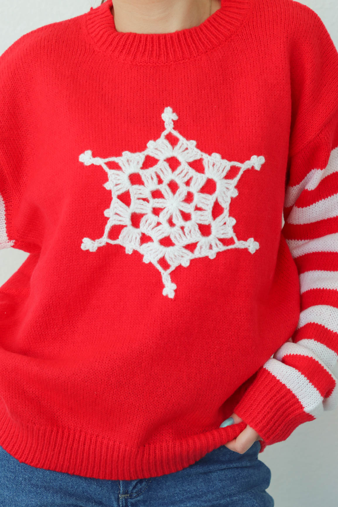 girl wearing red snowflake and striped sweater