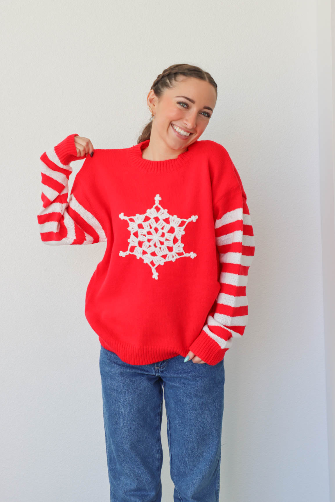 girl wearing red snowflake and striped sweater