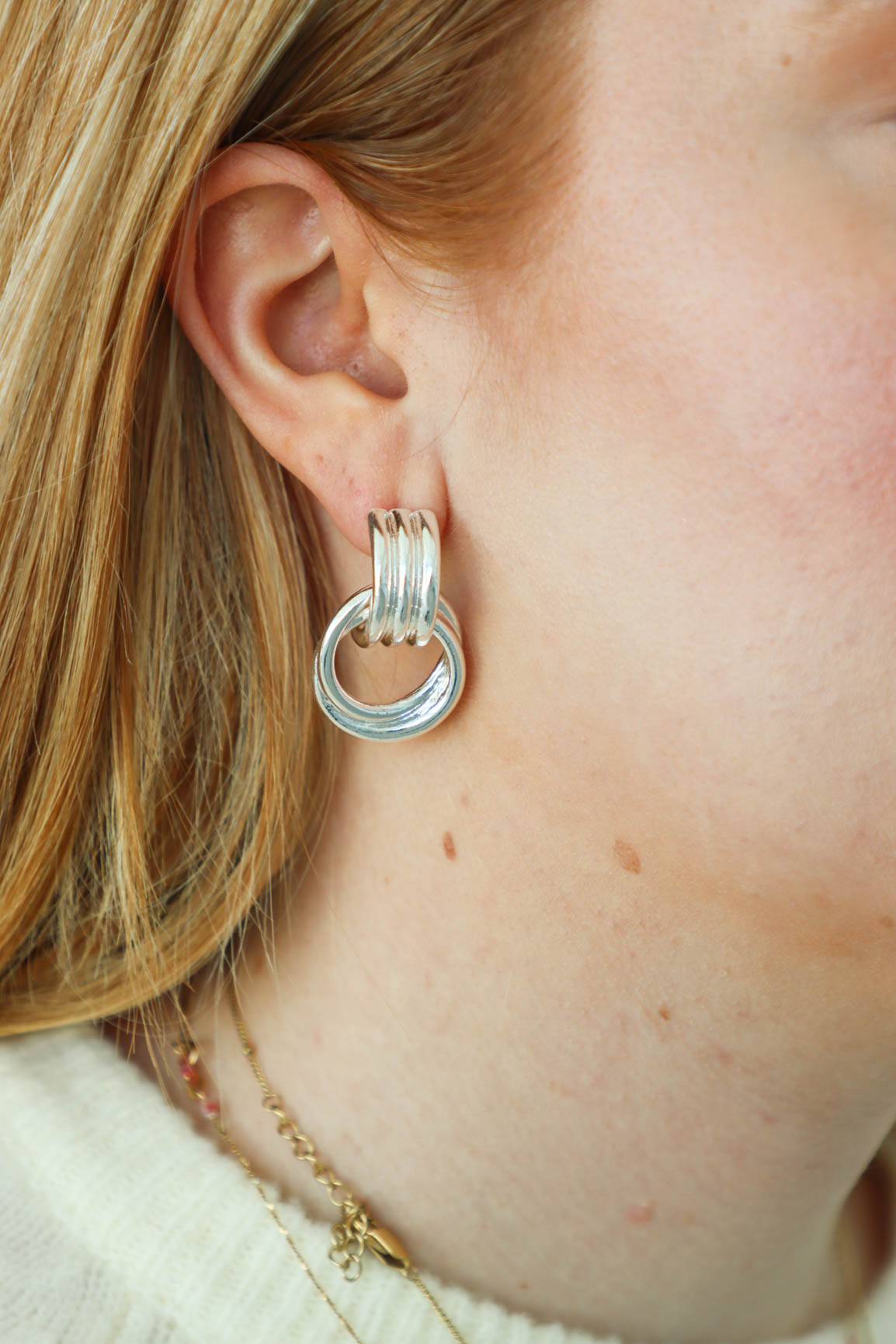 girl wearing silver earrings