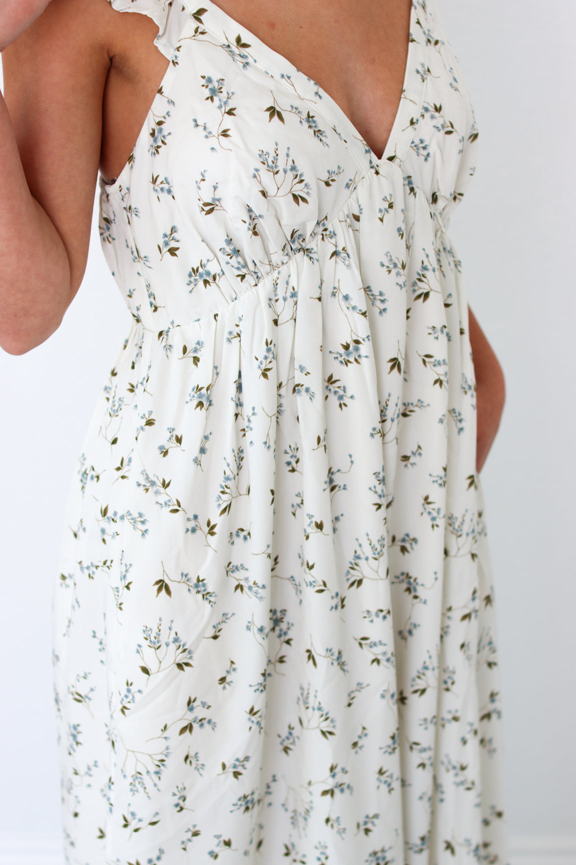 White floral dress with a plain background