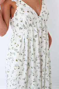 White floral dress with a plain background