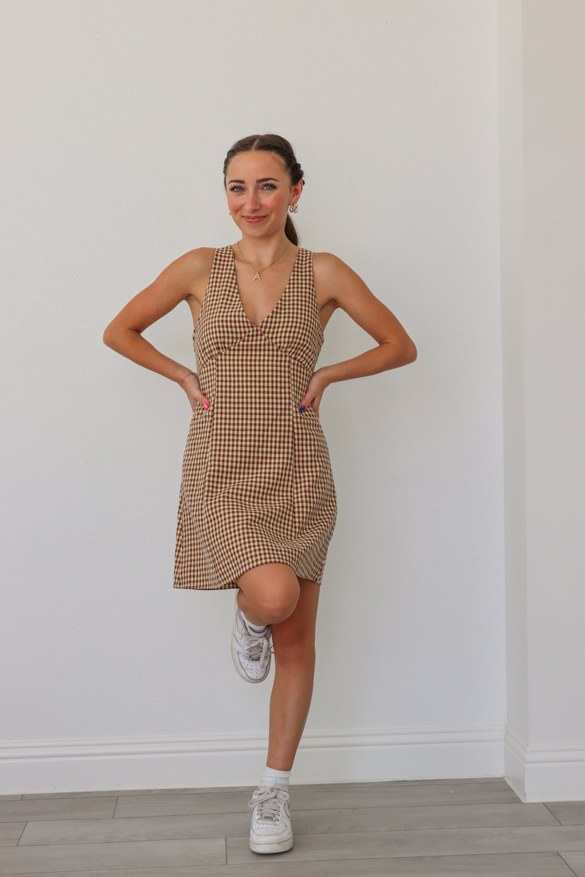 girl wearing tan checker print dress