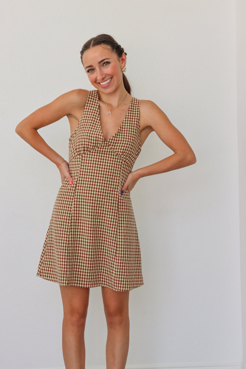 girl wearing tan checker print dress