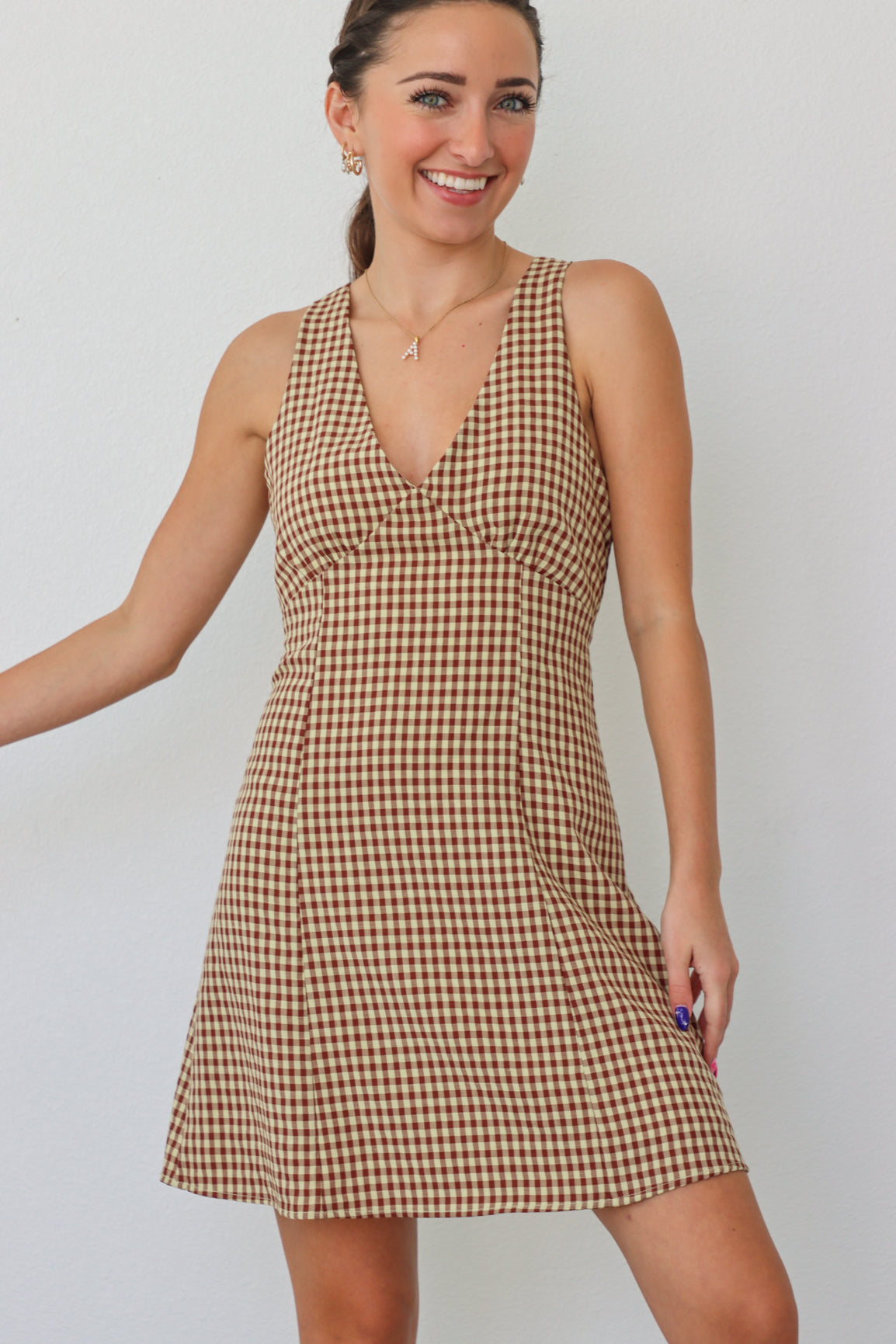 girl wearing tan checker print dress