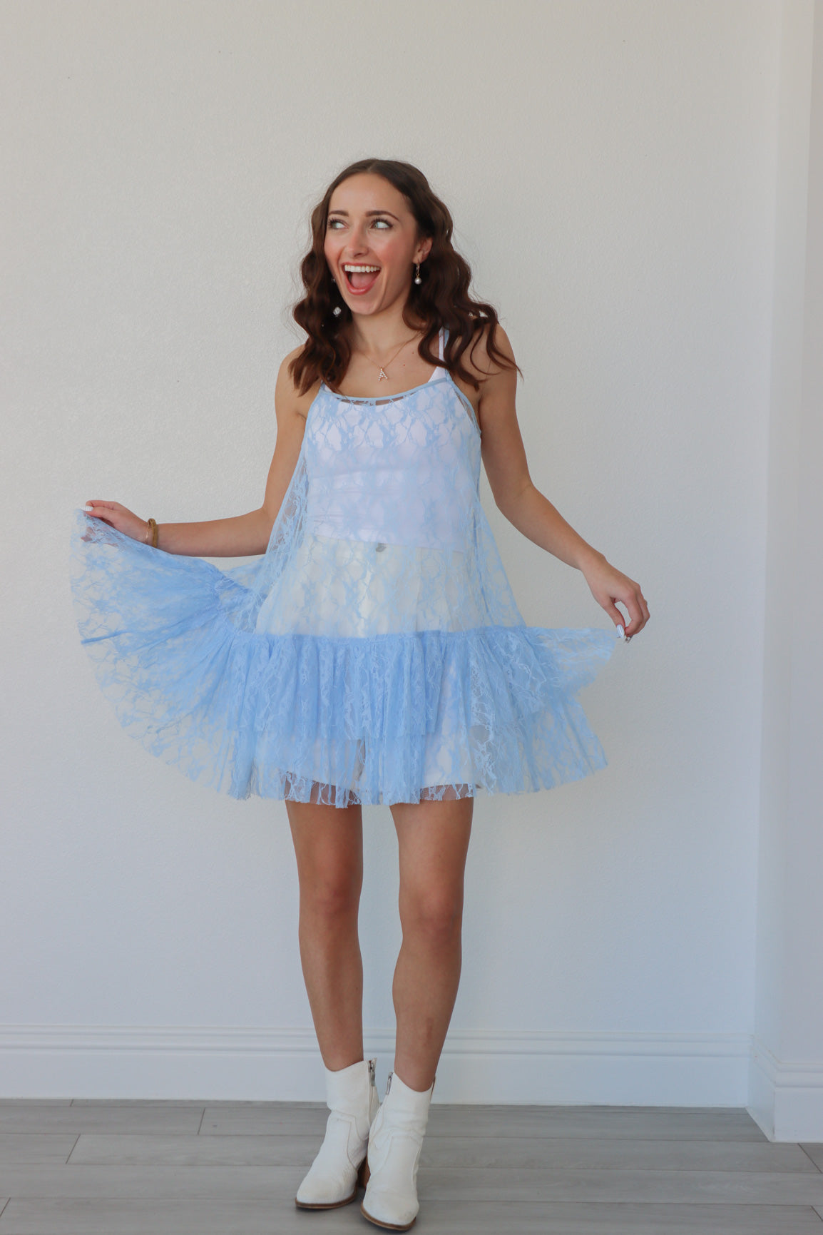 girl wearing light blue lace overlay dress