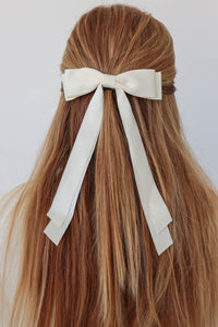 girl wearing cream hair bow