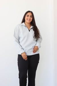 girl wearing gray quarter zip sweatshirt