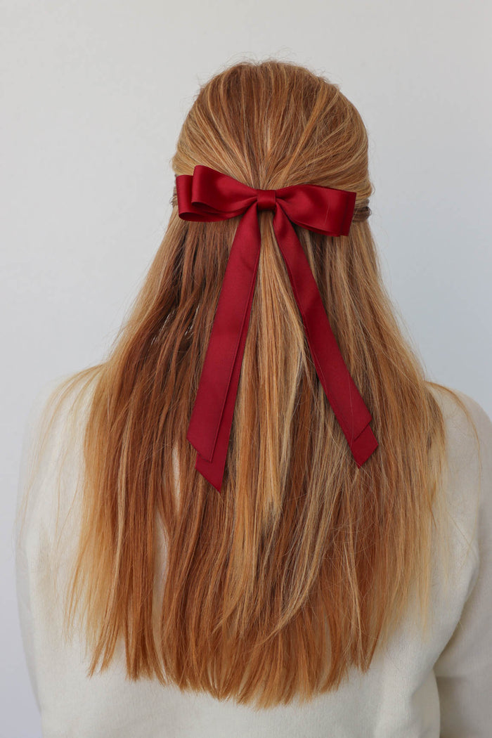 girl wearing dark red hair bow