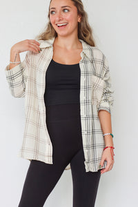 girl wearing cream plaid button up top