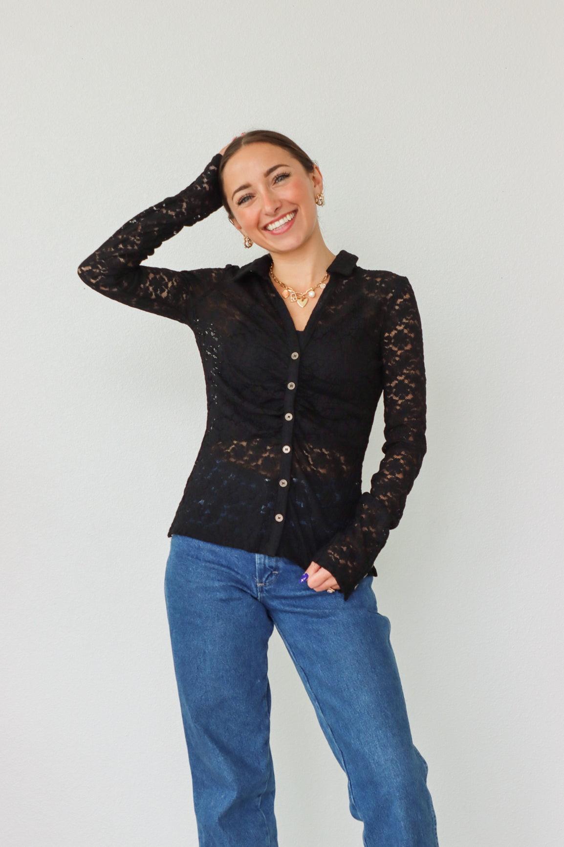 girl wearing black lace button down long sleeve top